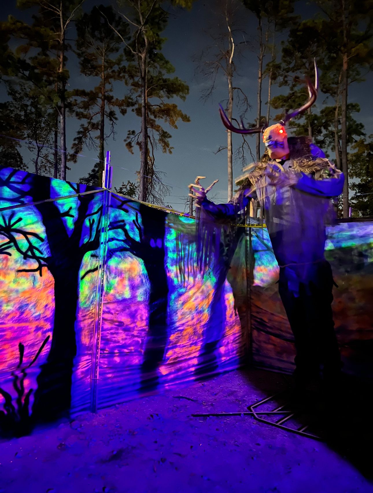 Mysterious character in the Apocalypse Maze - Houston's immersive horror experience with glowing effects and theatrical atmosphere